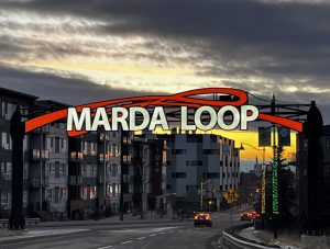 The gate to Marda Loop is lit up in the early morning.